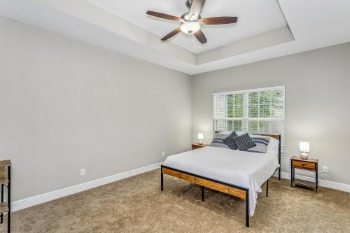 a bedroom with a bed and a ceiling fan at Lovely Town-home in Pensacola in Pensacola