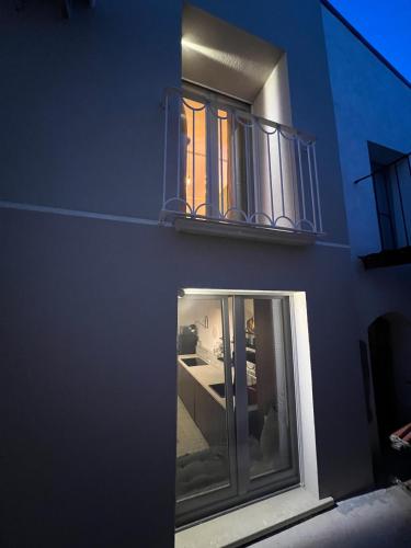 a blue building with a window and a balcony at RESIDENZA ORTENSIA in Petacciato