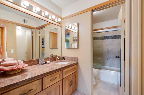 a bathroom with a sink and a shower at Frank Lloyd Wright Condo at Biltmore Golf Course in Phoenix