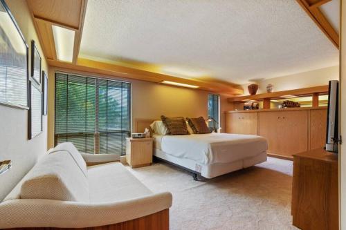a bedroom with a bed and a large window at Frank Lloyd Wright Condo at Biltmore Golf Course in Phoenix