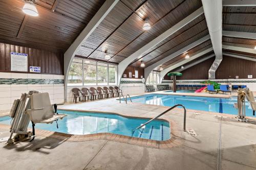 a swimming pool in a building with an indoor pool at AmericInn by Wyndham Rochester Near Mayo Clinic in Rochester