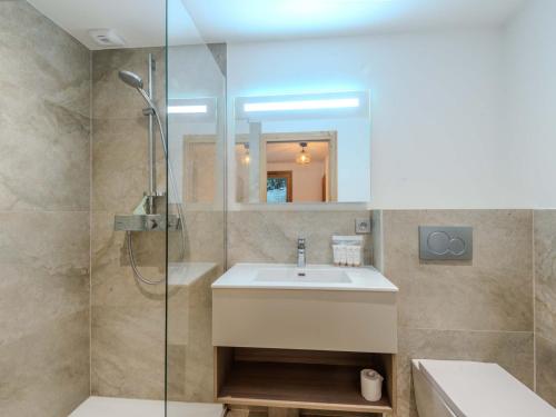 une salle de bain avec un lavabo et une douche en verre dans l'établissement Bel appart 3* refait à neuf au pied des pistes, centre Morzine, 4 pers, terrasse, wifi, garage - FR-1-754-58, à Morzine