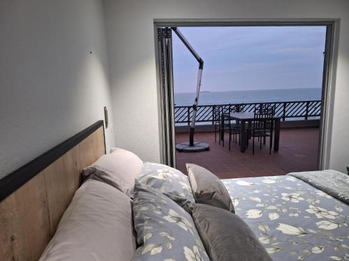 a bedroom with a bed and a view of the ocean at SEA FACING modern 3-bedroom apartment, Umdloti in Umdloti