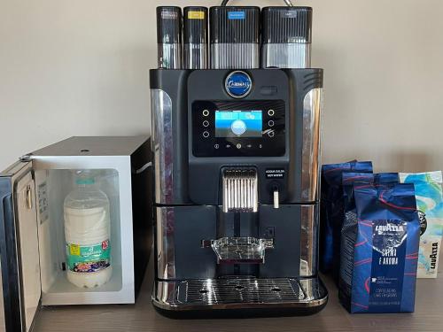 a coffee maker sitting on a table next to a box at Hotel Tyc Soleti Hotels in Rimini