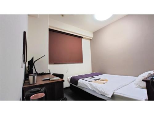 a room with a bed and a projection screen at Hotel Area One Oita - Vacation STAY 99711v in Oita