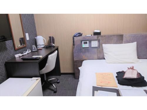 a hotel room with a desk and a bed and a desk at Hotel Area One Oita - Vacation STAY 99735v in Oita