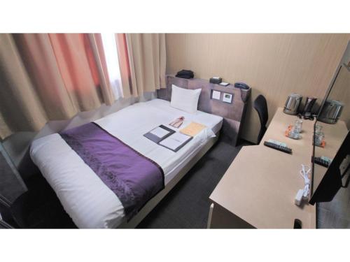 a hotel room with a bed and a desk at Hotel Area One Oita - Vacation STAY 99740v in Oita