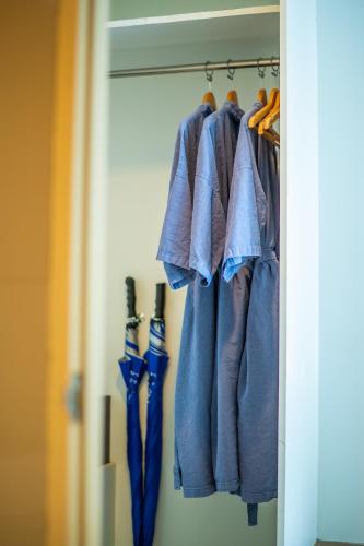 a group of umbrellas are hanging in a closet at The Lantern Resorts Patong - SHA Extra Plus in Patong Beach