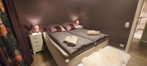 a bedroom with a bed with two candles on it at Cozy and warm just like at home, Free P, Big terrace in Langevåg
