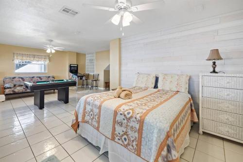 a bedroom with a bed with a teddy bear laying on it at Waterfront home with pool and gameroom! in Hernando Beach