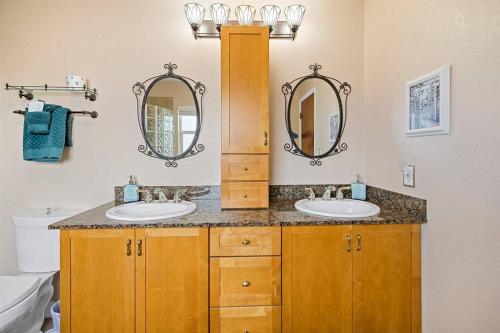 a bathroom with two sinks and two mirrors at Waterfront home with pool and gameroom! in Hernando Beach