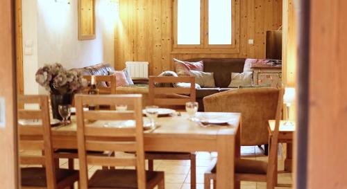 a living room with a table and chairs and a couch at Slemish Apt in Morzine