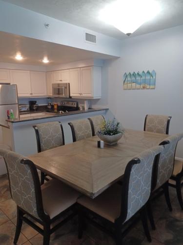 a dining room table with chairs and a kitchen at Ocean Walk Resort - 3BR 9th Floor Amazing Ocean Front View in Daytona Beach