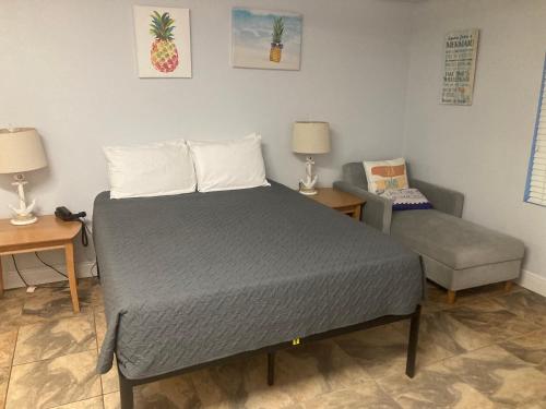 a bed and a chair in a room at Ocean Walk Resort - 3BR 9th Floor Amazing Ocean Front View in Daytona Beach