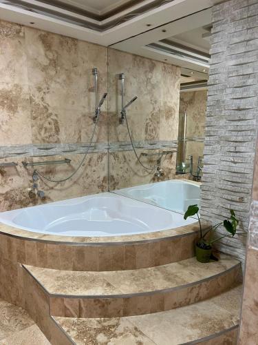 a large bathroom with a tub in a room at African Haven Guest House in Cape Town