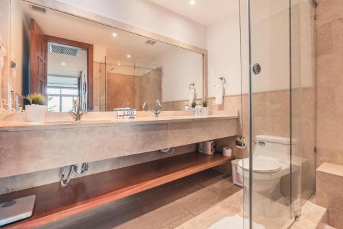 a bathroom with a sink and a toilet and a mirror at Wonderful Apt at Casa de Campo in El Infiernito