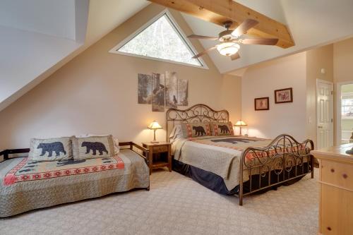 two beds in a attic bedroom with a skylight at Enchanted Forest Cottage with Hot Tub! in Hiawassee