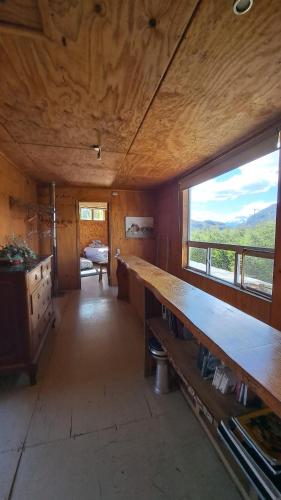 a room with a large wooden table in a room at Casa del río in Cochrane