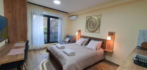 a bedroom with a bed with pillows on it at Studio apartmani Anika in Vrdnik