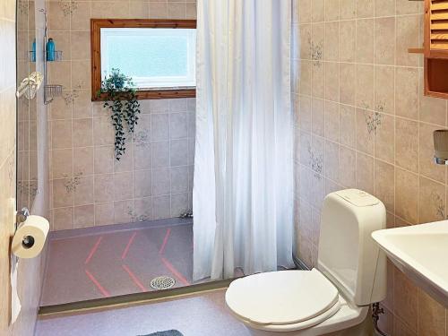 a bathroom with a toilet and a shower with a window at Holiday home Grängesberg in Grängesberg