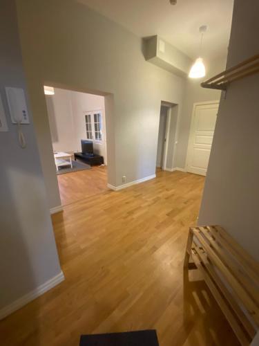 an empty living room with a couch and a wooden floor at Home Inn KHT15 in Stockholm