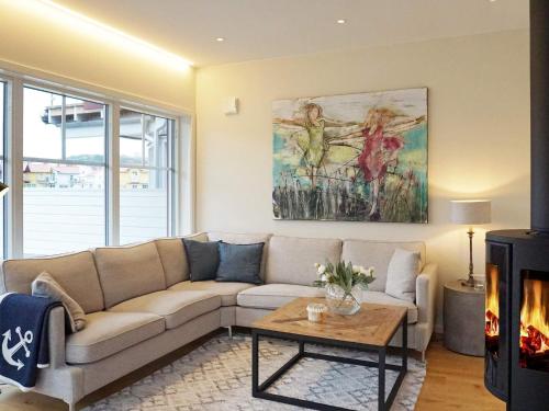 a living room with a couch and a table at 4 star holiday home in Hamburgsund in Hamburgsund