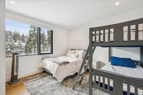 a bedroom with two bunk beds and a window at NEW LISTING! Diamond Run at Palisades Tahoe - Pet Friendly and NEW hot tub! in Olympic Valley
