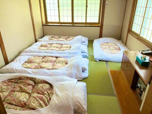 a room with four mattresses on the floor at Hotel Montblanc Hakuba - Vacation STAY 97822v in Hakuba