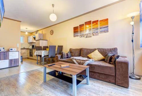a living room with a couch and a table at Koserow, Koserower Strand - App in Ostseebad Koserow
