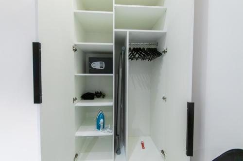a room with white shelves and a mirror at LUX Апартаменти MYFREEDOM поруч метро Театральна, Хрещатик in Kyiv