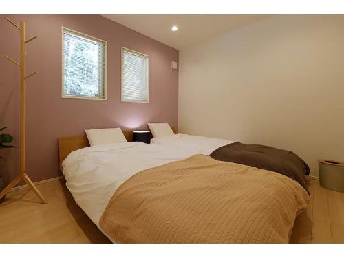 two beds in a room with two windows at Class Vesso Tateshina - Vacation STAY 51972v in Chino