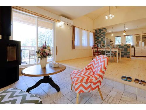 a living room with a table and a chair at Class Vesso Tateshina - Vacation STAY 51965v in Chino