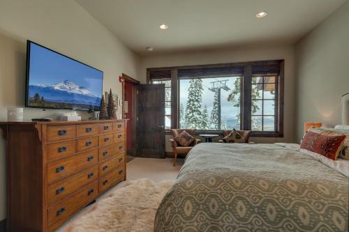a bedroom with a large bed and a large television at Gondola Getaway- Ski-in Ski-out - Luxury 4 BR, Private Hot Tub, HOA Amenities in Truckee