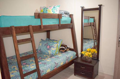 a bedroom with bunk beds with a cat laying on a bench at A Bless Apartamento in Salento