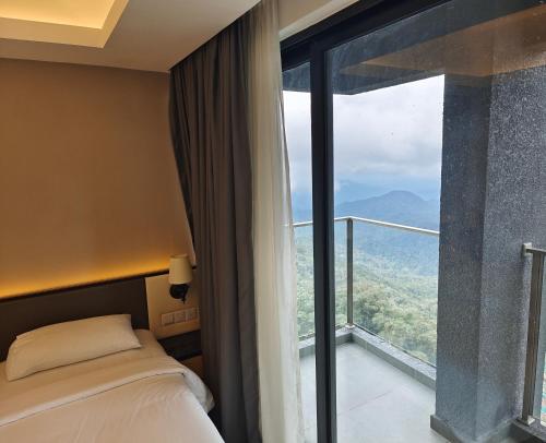 a room with a bed and a large window at Genting Hilltop Ion Delemen Homestay in Genting Highlands