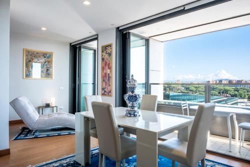 a dining room with a table and chairs and a large window at EuroSky Roma Eur in Rome