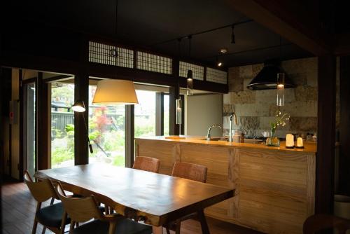 a kitchen with a wooden table and some chairs at Kusakimomotose - Vacation STAY 15482 in Yuzawa