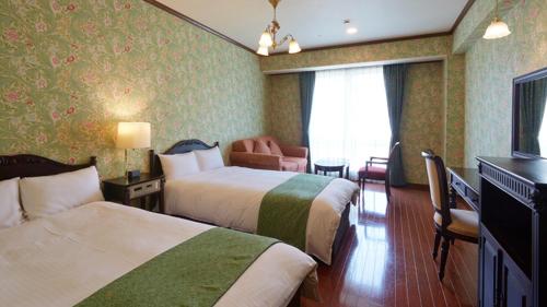 a hotel room with two beds and a chair at Old England Dogo Yamanote Hotel - Vacation STAY 76375v in Matsuyama