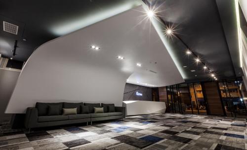 a living room with a couch and a checkered floor at Green Hotel in Magong