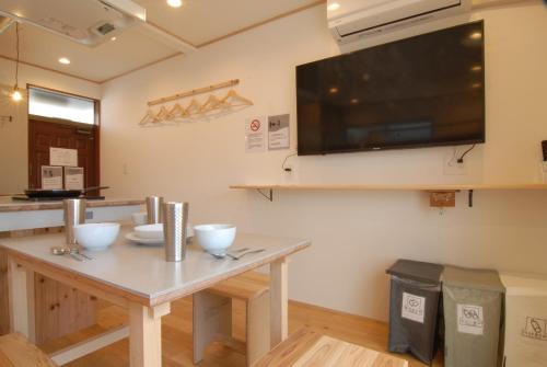 a dining room with a table and a flat screen tv at futaba heights - Vacation STAY 15415 in Tokyo