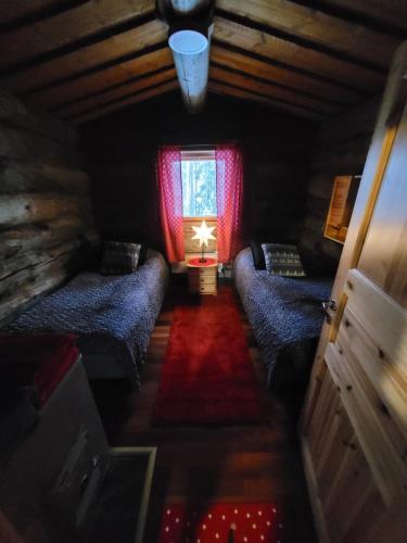 a room with two beds and a window at Pahtaja Chalet in Rovaniemi