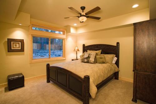 a bedroom with a bed and a ceiling fan at Olive Branch - Private Hot Tub, Media Room, Pet-Friendly, Near Northstar! in Carnelian Bay