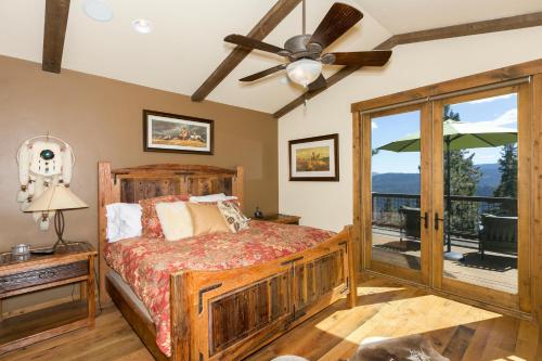 a bedroom with a bed and a balcony at Overlook Lake View Lodge at Tahoe Donner- Dog Friendly 4BR with Private Hot Tub in Truckee