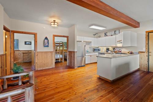 a kitchen with white appliances and wooden floors at Shelter Cove Resort & Marina in Odell Lake