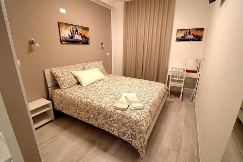 a small bedroom with a bed with two books on it at SENTIERI DEL GARDA in Arco