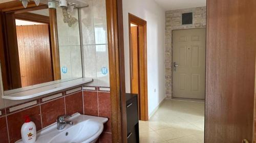 a bathroom with a sink and a mirror at Apartment Paska in Novalja