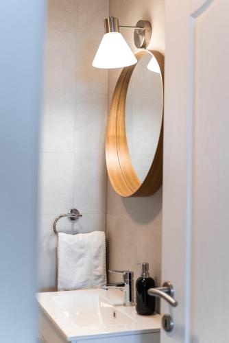 a bathroom with a sink and a mirror at New cosy apartments with private parking in Opatija