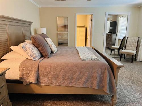 a bedroom with a large bed with pillows on it at Beach and Pool, what more do you need? in Clearwater Beach