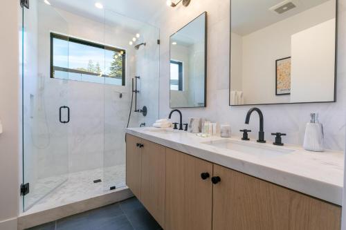 a bathroom with a shower and a sink and a mirror at Powder Run - Newly Built Palisades 3 Bedroom Townhome - Minutes to Village in Olympic Valley