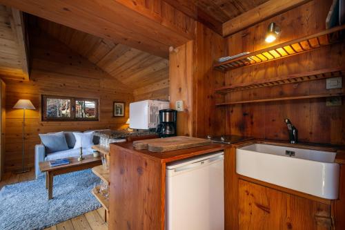 a kitchen and living room in a log cabin at Mazot les Tines in Chamonix-Mont-Blanc